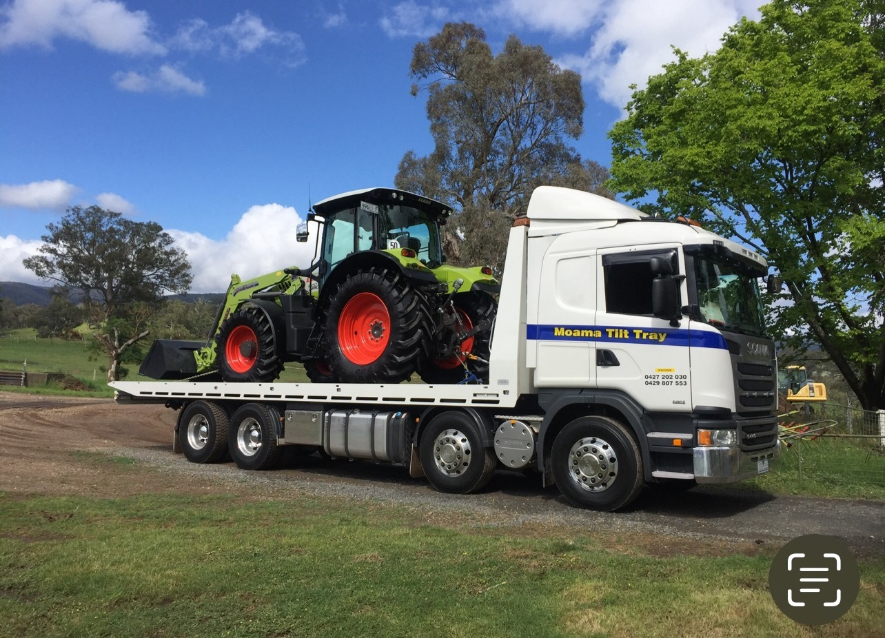 Truck transporting Claas tractor